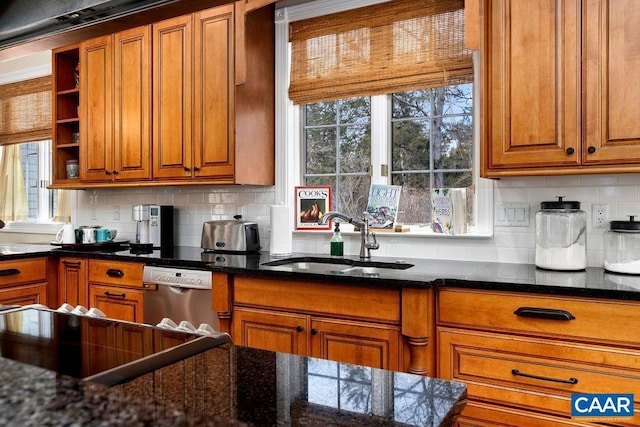 kitchen featuring dishwasher, a wealth of natural light, decorative backsplash, brown cabinetry, and a sink