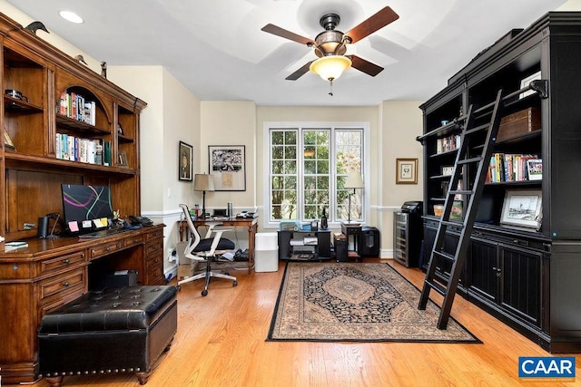 office with light wood finished floors and ceiling fan