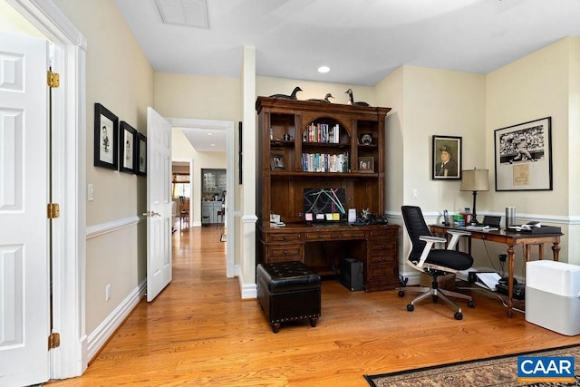 office featuring light wood finished floors, visible vents, recessed lighting, and baseboards