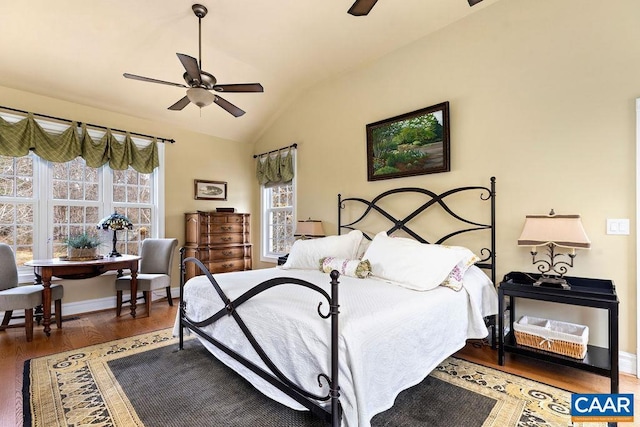 bedroom with multiple windows, baseboards, lofted ceiling, and wood finished floors