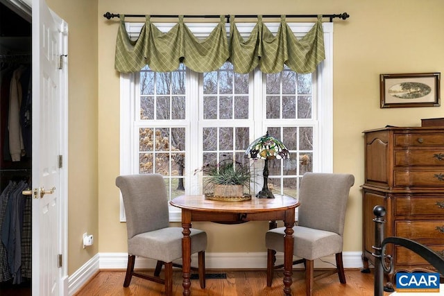 dining room with baseboards and wood finished floors