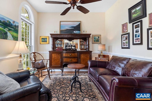 living area featuring wood finished floors and ceiling fan