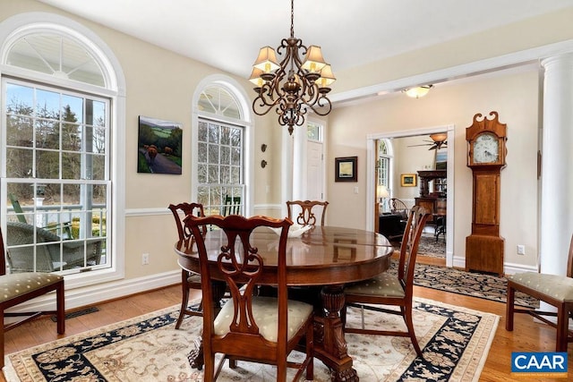 dining area featuring a wealth of natural light, light wood-type flooring, and baseboards