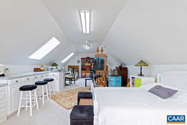 bedroom featuring light carpet and vaulted ceiling with skylight