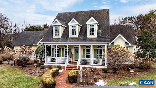 cape cod-style house with covered porch and roof with shingles