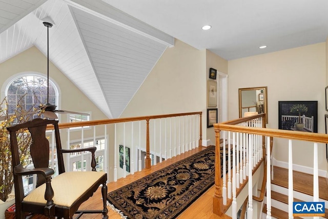 hall featuring an upstairs landing, wood finished floors, recessed lighting, baseboards, and vaulted ceiling