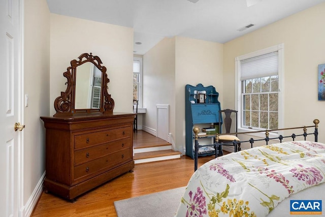 bedroom with visible vents, baseboards, and light wood-style floors