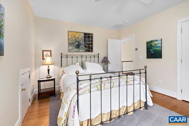 bedroom with baseboards and wood finished floors