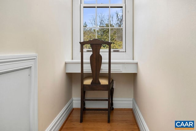 interior details with baseboards and wood finished floors