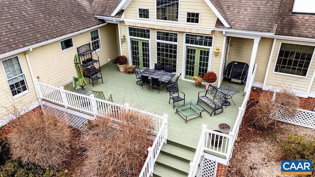 deck featuring stairway and a grill