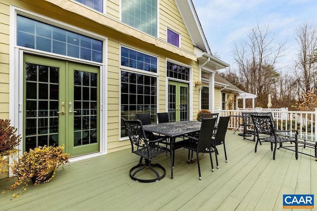 wooden deck with outdoor dining area and french doors