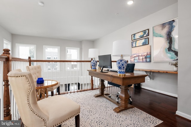 office area featuring baseboards and wood finished floors