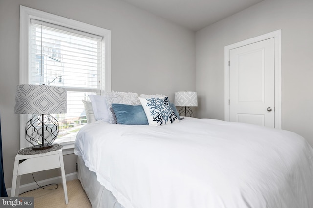 bedroom with carpet floors and baseboards