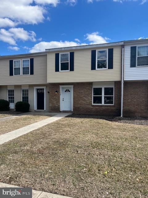 townhome / multi-family property with brick siding