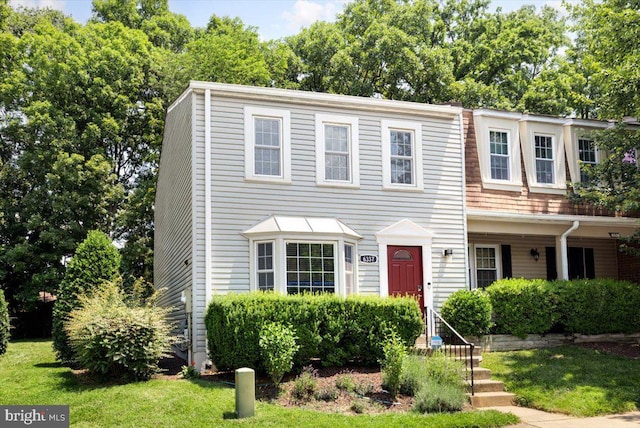 view of property featuring a front lawn