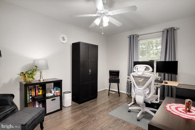 office featuring ceiling fan, wood finished floors, and baseboards