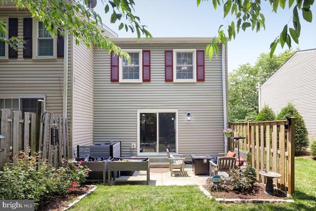 back of property featuring a yard, a patio area, fence, and central air condition unit