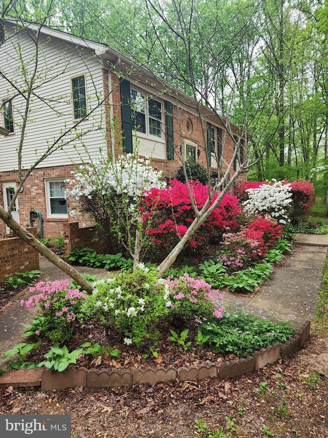 view of side of property with brick siding