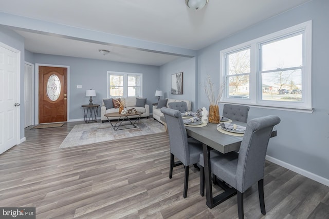 dining area with wood finished floors and baseboards