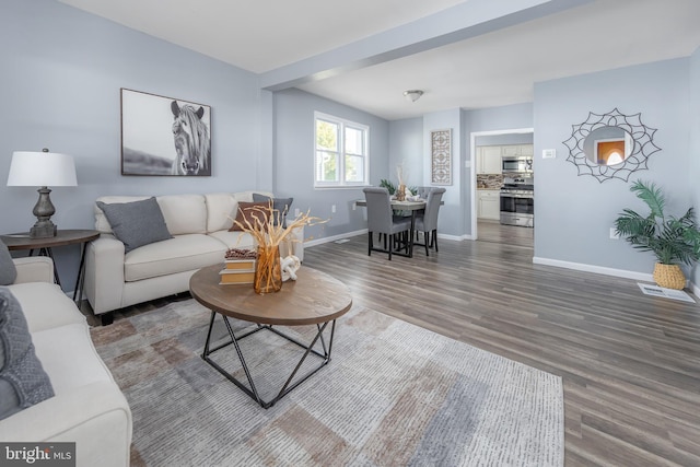 living room with wood finished floors and baseboards