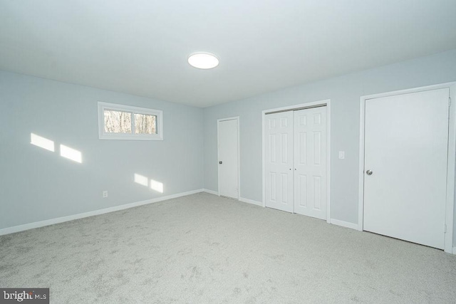 unfurnished bedroom with carpet flooring and baseboards