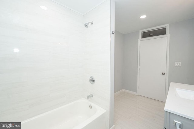 bathroom with shower / washtub combination, vanity, and baseboards