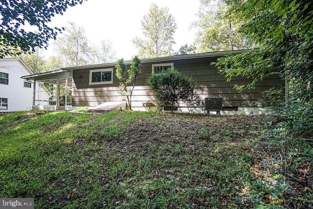 ranch-style house with a carport and central AC unit