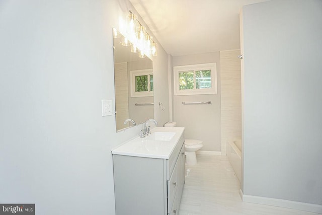 full bath with toilet, baseboards, and vanity