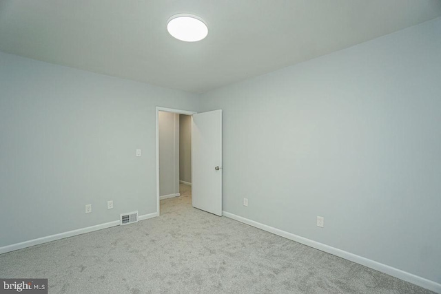 unfurnished bedroom with carpet floors, visible vents, and baseboards