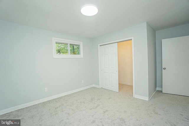 unfurnished bedroom featuring carpet floors and baseboards