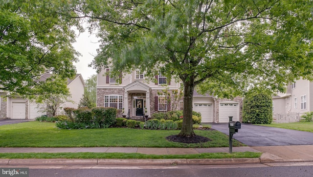 6735 Eckert Ct, Warrenton, VA 20187 - view of front facade with stone siding, driveway, a front lawn, and a garage