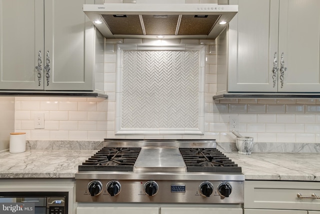 6735 Eckert Ct, Warrenton, VA 20187 - kitchen with stainless steel gas cooktop, under cabinet range hood, decorative backsplash, and light stone counters