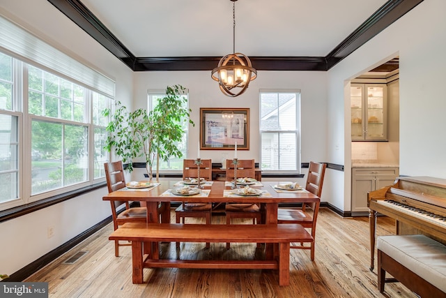6735 Eckert Ct, Warrenton, VA 20187 - dining area with light wood finished floors, a chandelier, crown molding, and baseboards