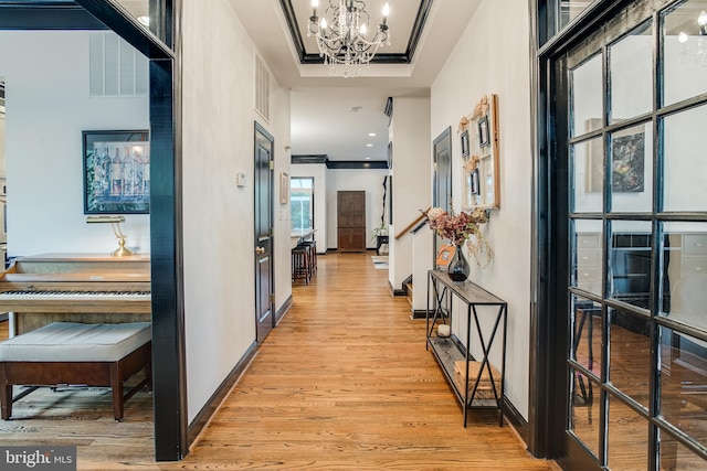 6735 Eckert Ct, Warrenton, VA 20187 - corridor with light wood-style flooring, a chandelier, and baseboards
