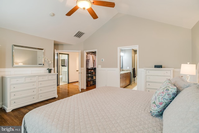 6735 Eckert Ct, Warrenton, VA 20187 - bedroom featuring a walk in closet, connected bathroom, wood finished floors, high vaulted ceiling, and a wainscoted wall