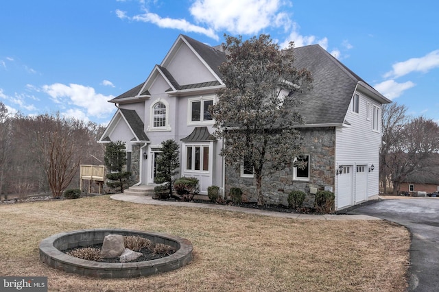 traditional-style house with driveway, a standing seam roof, stone siding, roof with shingles, and metal roof