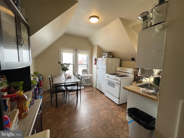 kitchen featuring lofted ceiling, white appliances, light countertops, and a sink