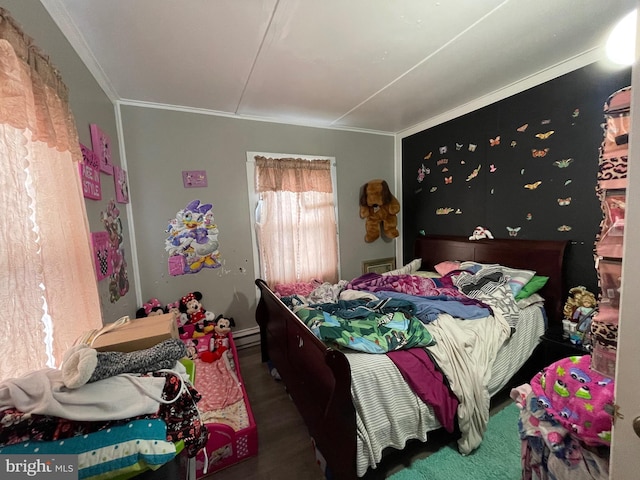 bedroom featuring crown molding and wood finished floors