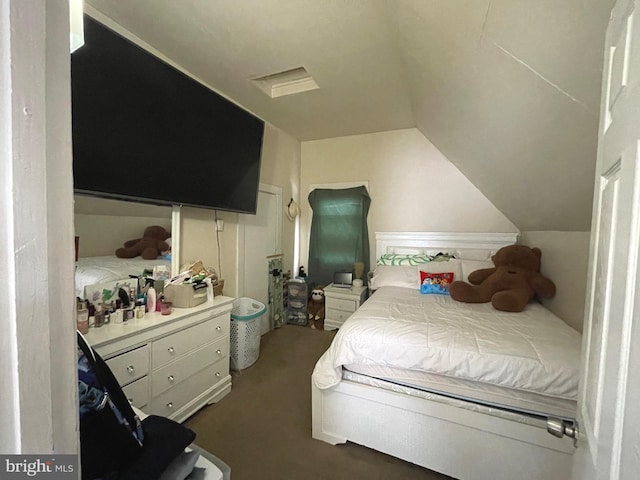 bedroom with lofted ceiling and dark carpet