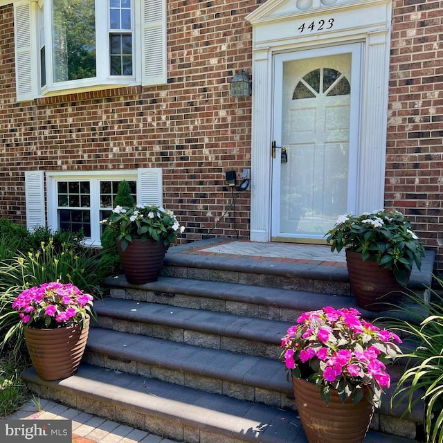 property entrance with brick siding