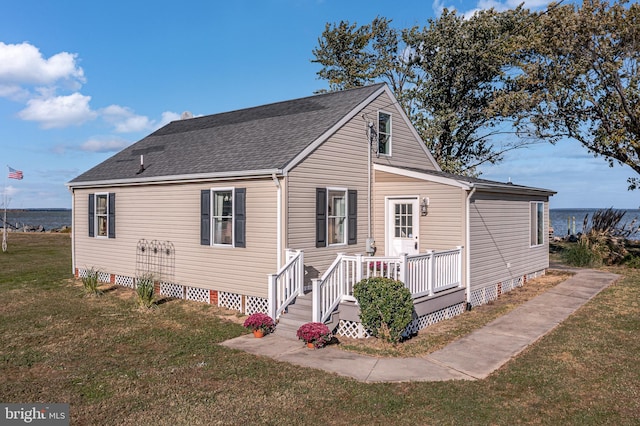 view of front of house featuring crawl space, a wooden deck, a front lawn, and roof with shingles