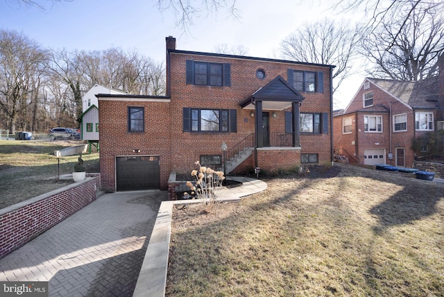 view of front facade featuring a garage, driveway, brick siding, and a chimney