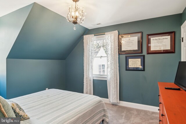 carpeted bedroom featuring visible vents, baseboards, lofted ceiling, and an inviting chandelier