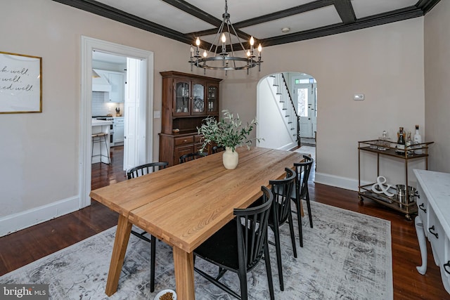 dining area featuring dark wood finished floors, arched walkways, baseboards, a chandelier, and stairs