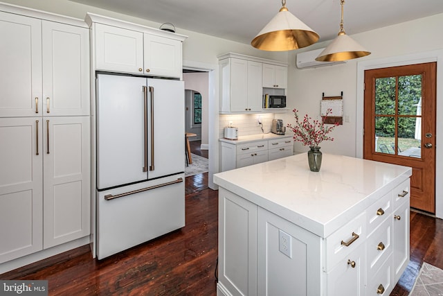 kitchen with high end fridge, dark wood-style flooring, decorative backsplash, white cabinets, and black microwave