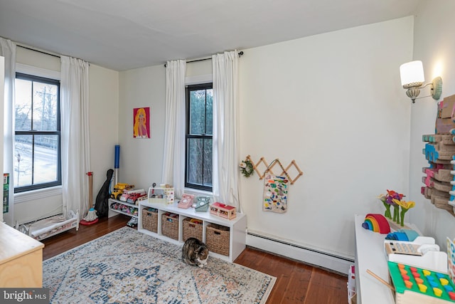 playroom with wood finished floors and baseboard heating