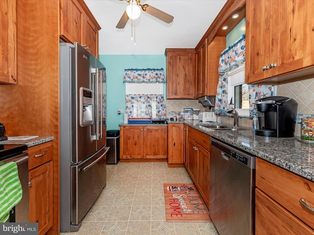 kitchen with backsplash, appliances with stainless steel finishes, brown cabinets, and a sink