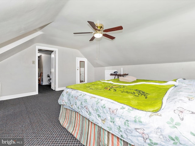 bedroom with baseboards, dark carpet, vaulted ceiling, and a ceiling fan