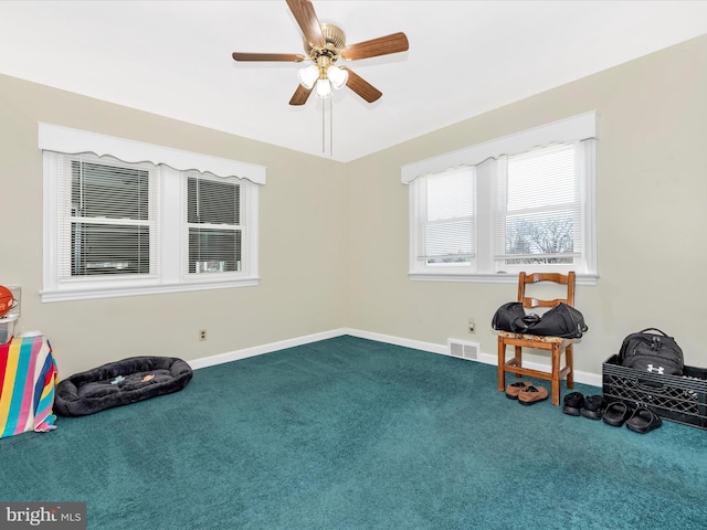 misc room with ceiling fan, carpet floors, visible vents, and baseboards