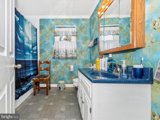 bathroom with brick floor, vanity, baseboards, wallpapered walls, and crown molding